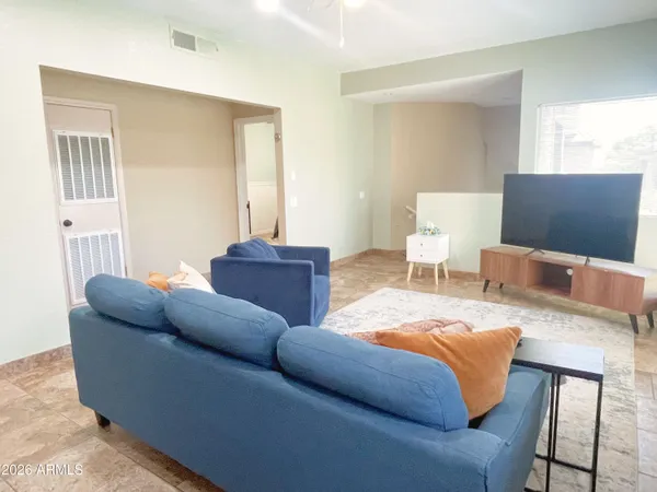 a living room with furniture and a flat screen tv