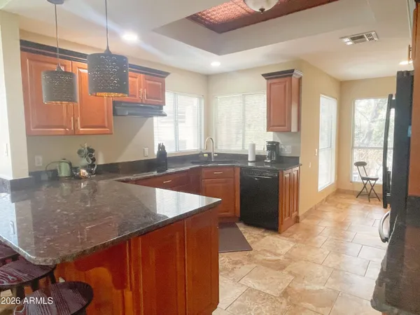 a kitchen with a sink a counter top space and appliances