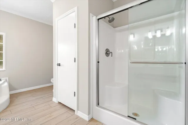a bathroom with a glass shower door