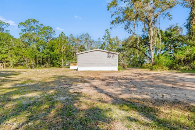 a view of a yard with a tree