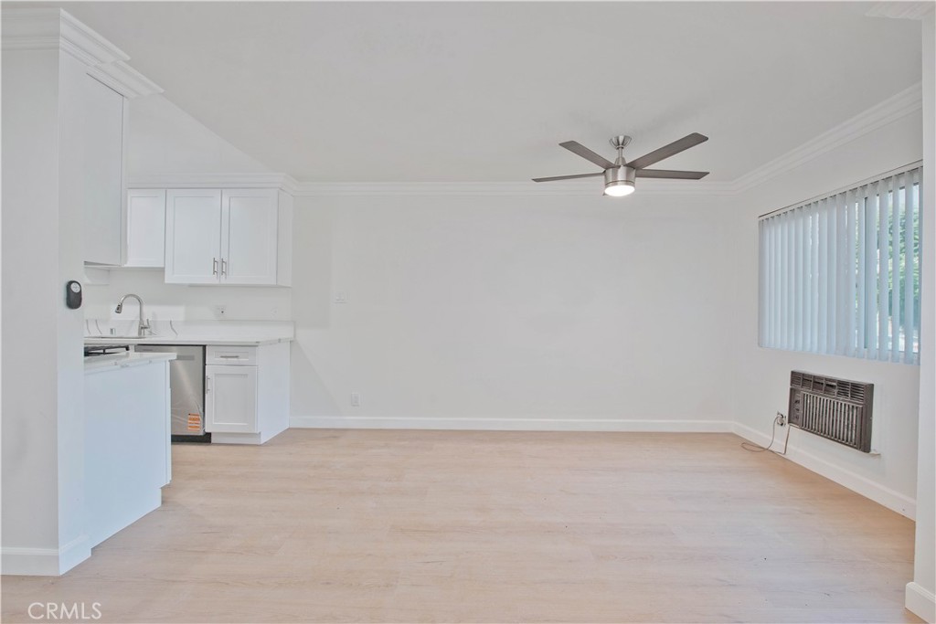 5415 Newcastle Avenue, Unit 18 Encino, CA 91316 - Photo 7 of 25 an empty room with a fireplace and a window