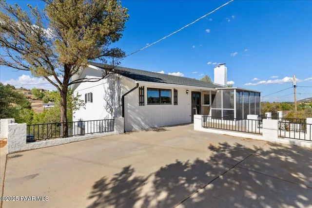 a balcony with table and chairs
