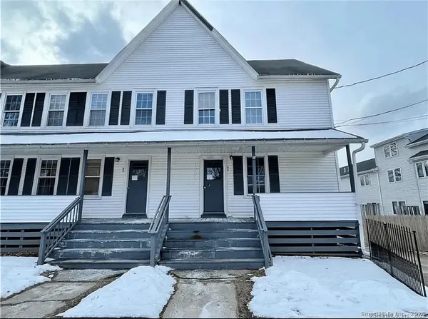 a view of a house with a small deck