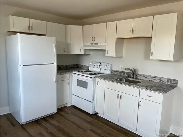 a white refrigerator freezer sitting inside of a kitchen