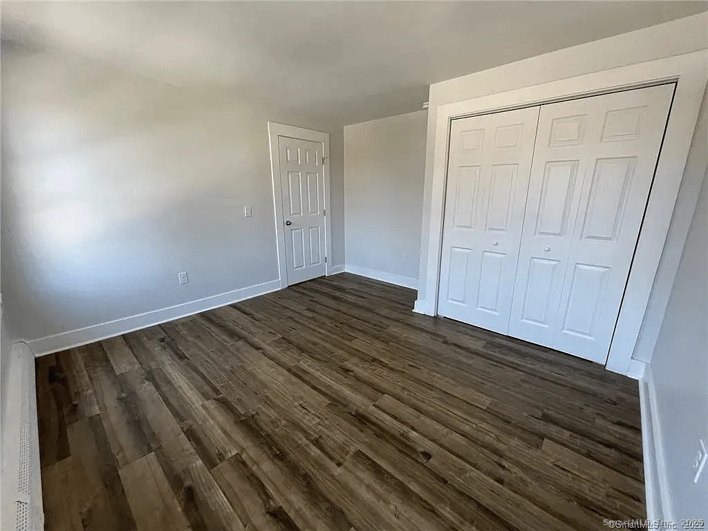 30 Anthony Street, Unit C Griswold, CT 06351 - Photo 6 of 11 a view of an empty room with wooden floor