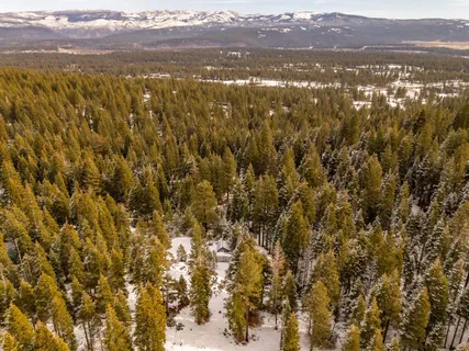 a view of a yard with snow on the road