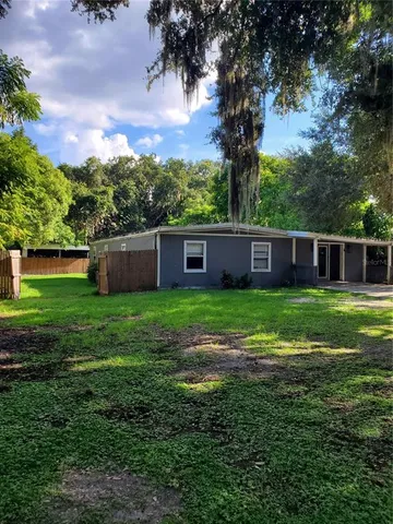 a view of house with backyard