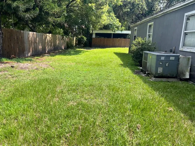 a backyard of a house with lots of green space