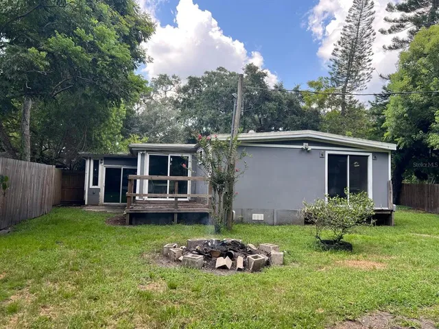 a backyard of a house with table and chairs