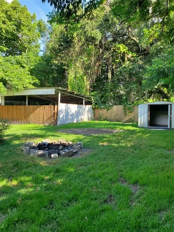 a view of a house with a yard and a park