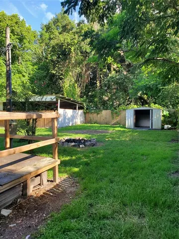 a view of a park with large trees
