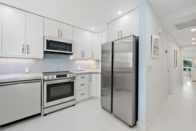 a kitchen with stainless steel appliances a refrigerator stove and microwave