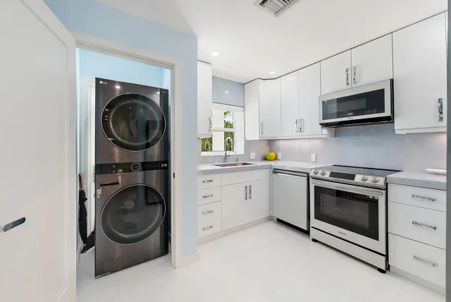 a kitchen with stainless steel appliances white cabinets and a sink