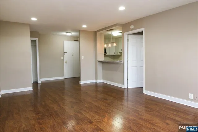 a kitchen with granite countertop a refrigerator and a sink