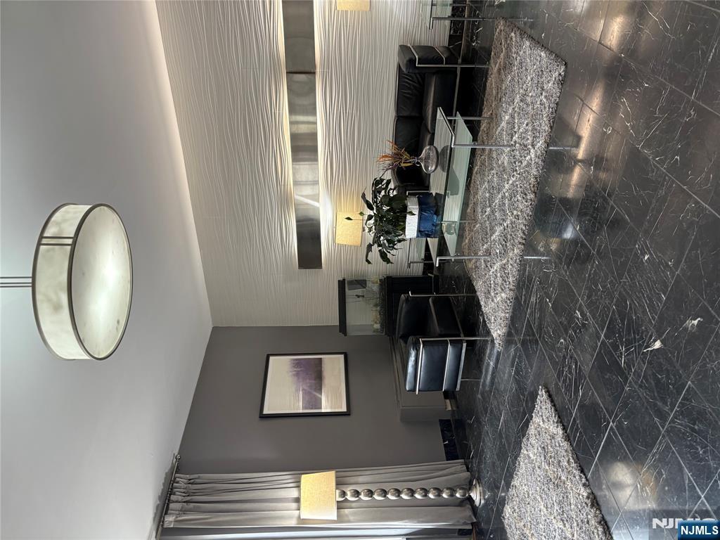 39 East 39th Street, Unit 412 Paterson, NJ 07514 - Photo 5 of 21 a living room with furniture a piano and a window