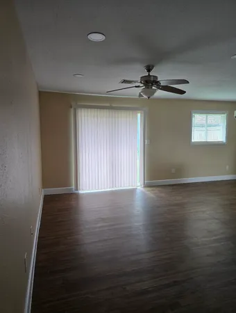 a view of a room with wooden floor and white walls