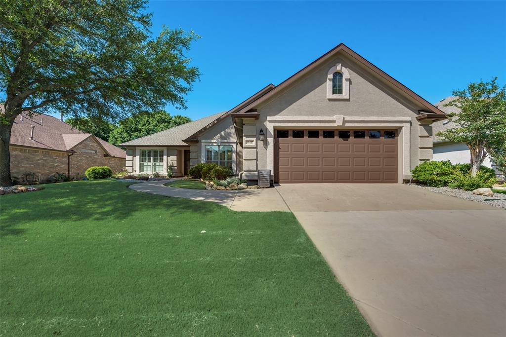 a front view of a house with yard and green space