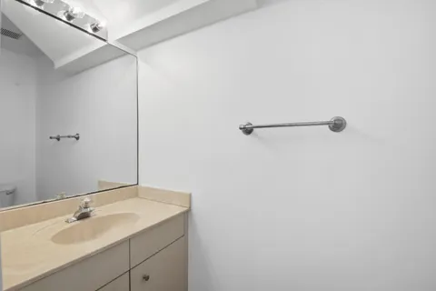a bathroom with a sink and mirror