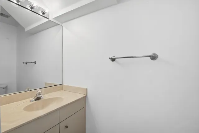 a bathroom with a sink and mirror