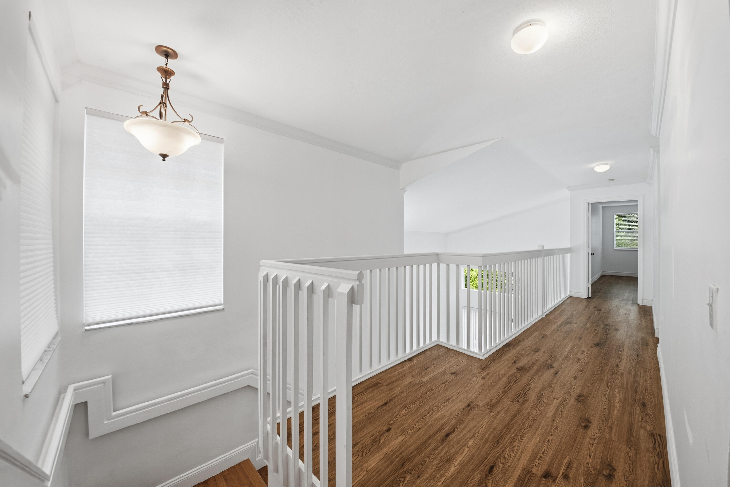 8021 Stirrup Cay Court Boynton Beach, FL 33436 - Photo 18 of 23 a view of a hallway with wooden floor and staircase
