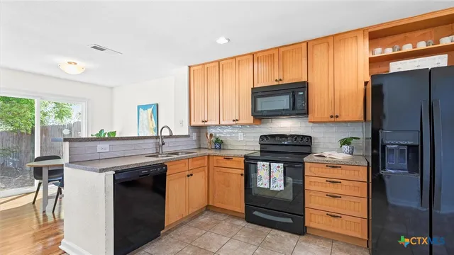 a kitchen with a stove microwave and refrigerator