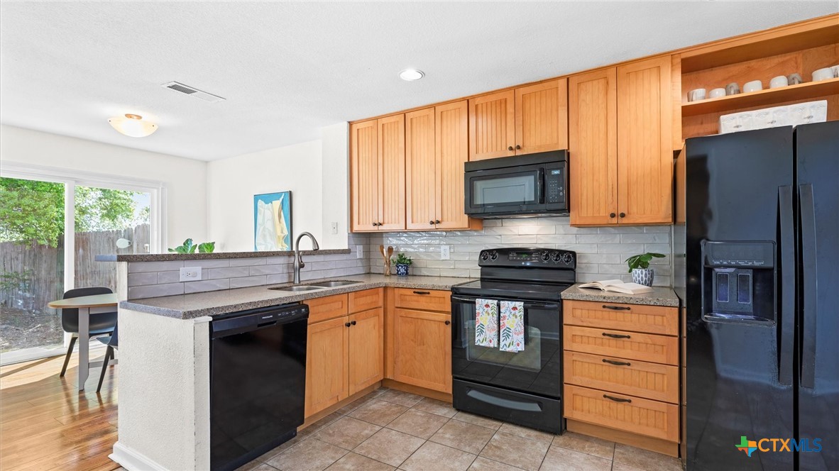 9739 Wagon Train Converse, TX 78109 - Photo 11 of 29 a kitchen with a stove microwave and refrigerator