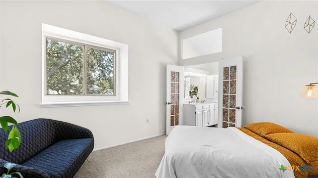 a bedroom with a bed and a window