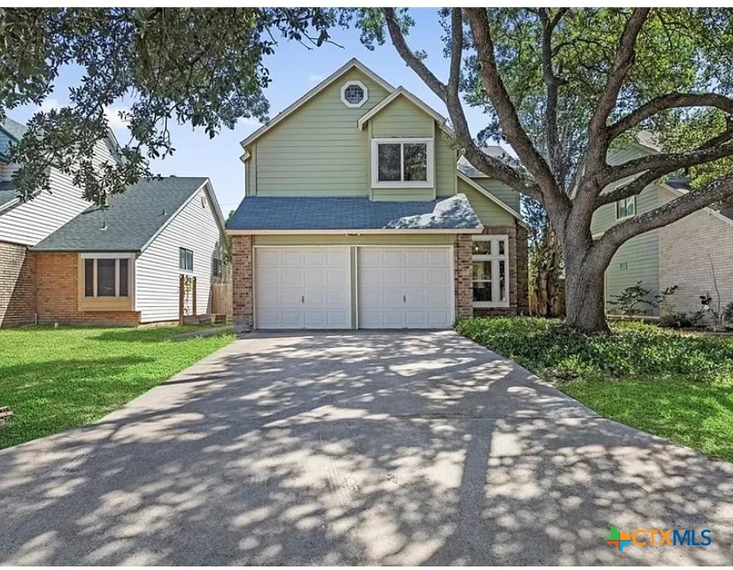 9739 Wagon Train Converse, TX 78109 - Photo 2 of 29 a view of a yard in front of a house with a large tree