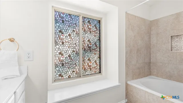 a bathroom with a bathtub and shower