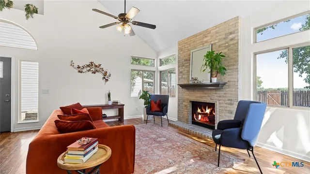 a living room with furniture and a fireplace