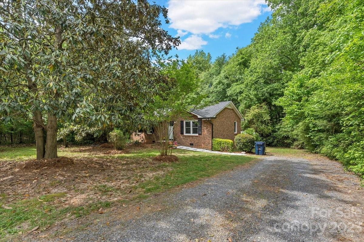 1525 Reservation Road Rock Hill, SC 29730 - Photo 23 of 31 a yellow house with trees in front of it