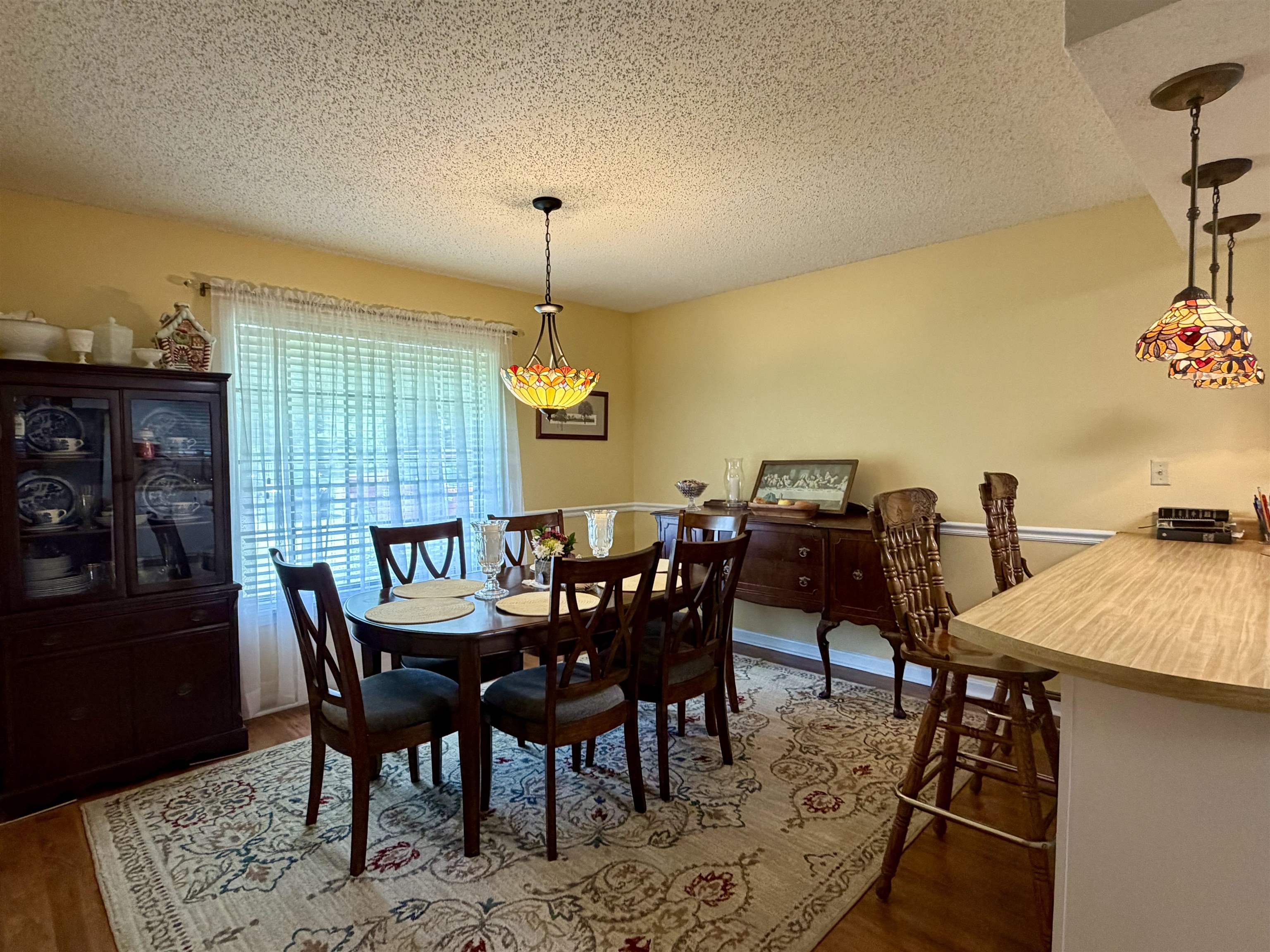 142 Treece Street Selmer, TN 38375 - Photo 10 of 36 Dining area featuring a decorative chandelier and wood-finish flooring