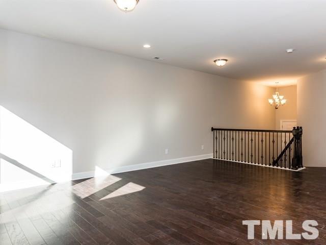 256 Alamosa Place Cary, NC 27519 - Photo 11 of 16 a view of a hallway with wooden floor