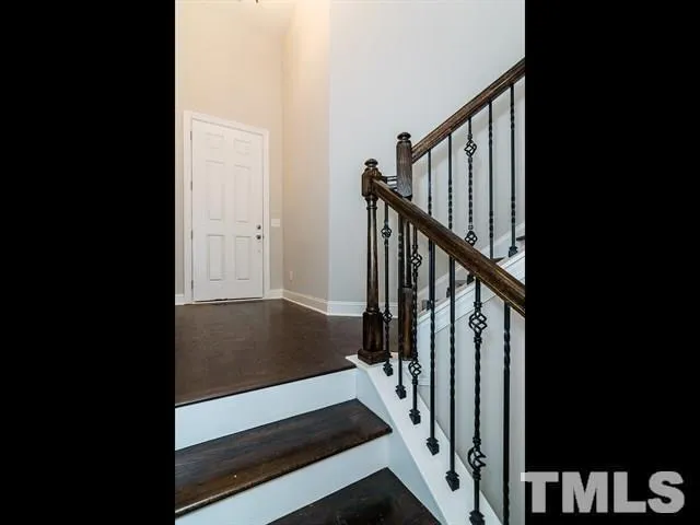 a view of entryway with wooden floor and stairs