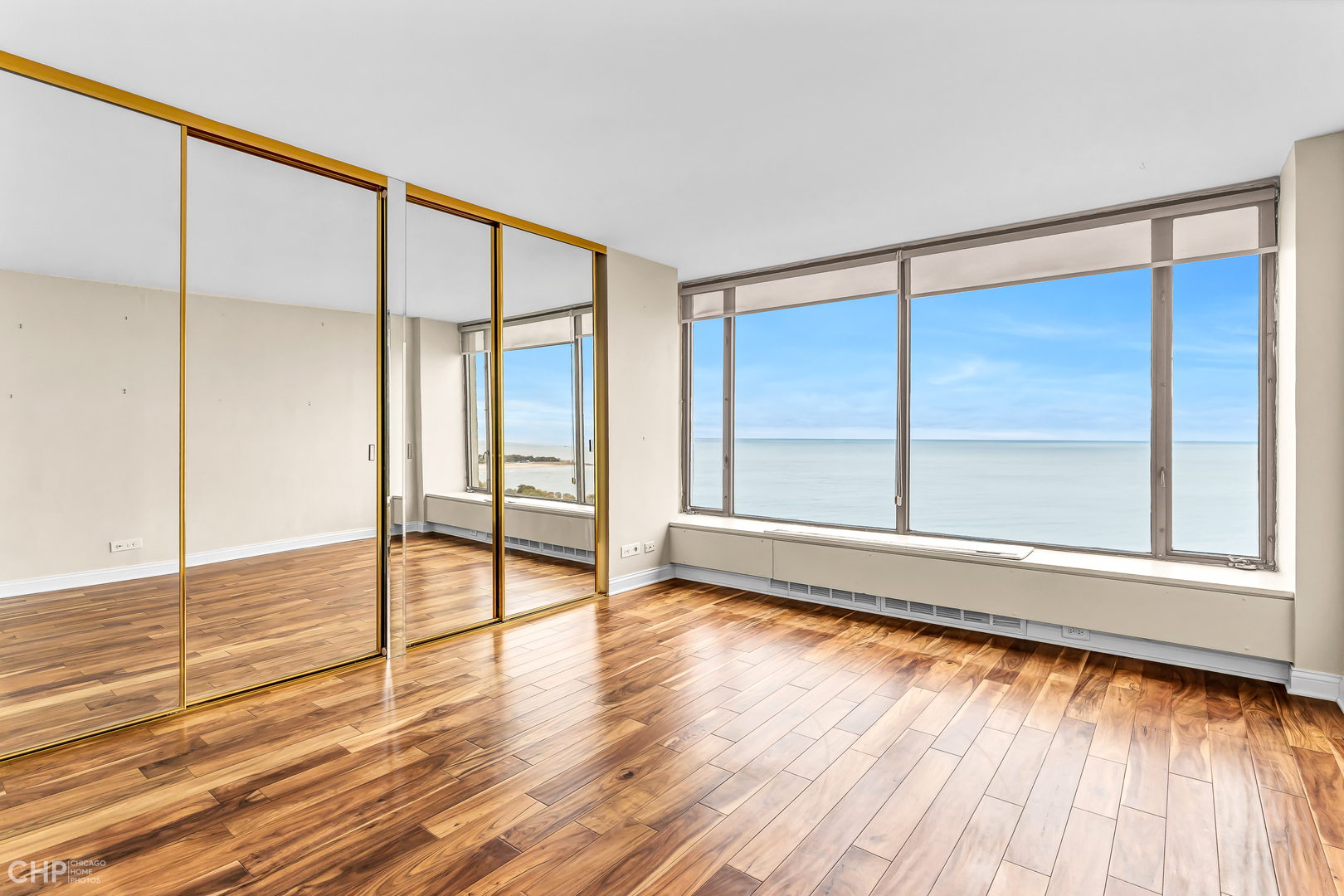 5455 North Sheridan Road, Unit 3501 Chicago, IL 60640 - Photo 11 of 29 a view of an empty room with wooden floor and a window