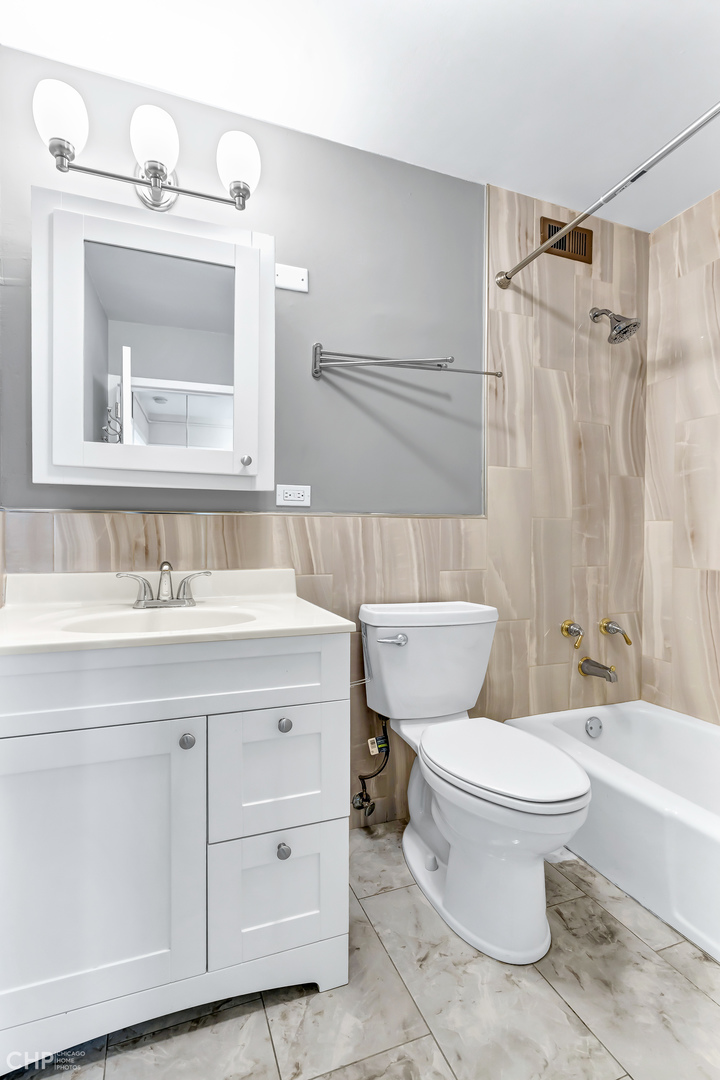 5455 North Sheridan Road, Unit 3501 Chicago, IL 60640 - Photo 16 of 29 a bathroom with a sink toilet a mirror and shower