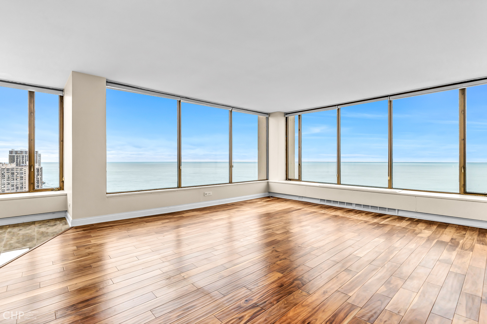 5455 North Sheridan Road, Unit 3501 Chicago, IL 60640 - Photo 2 of 29 a view of an empty room with wooden floor and a window