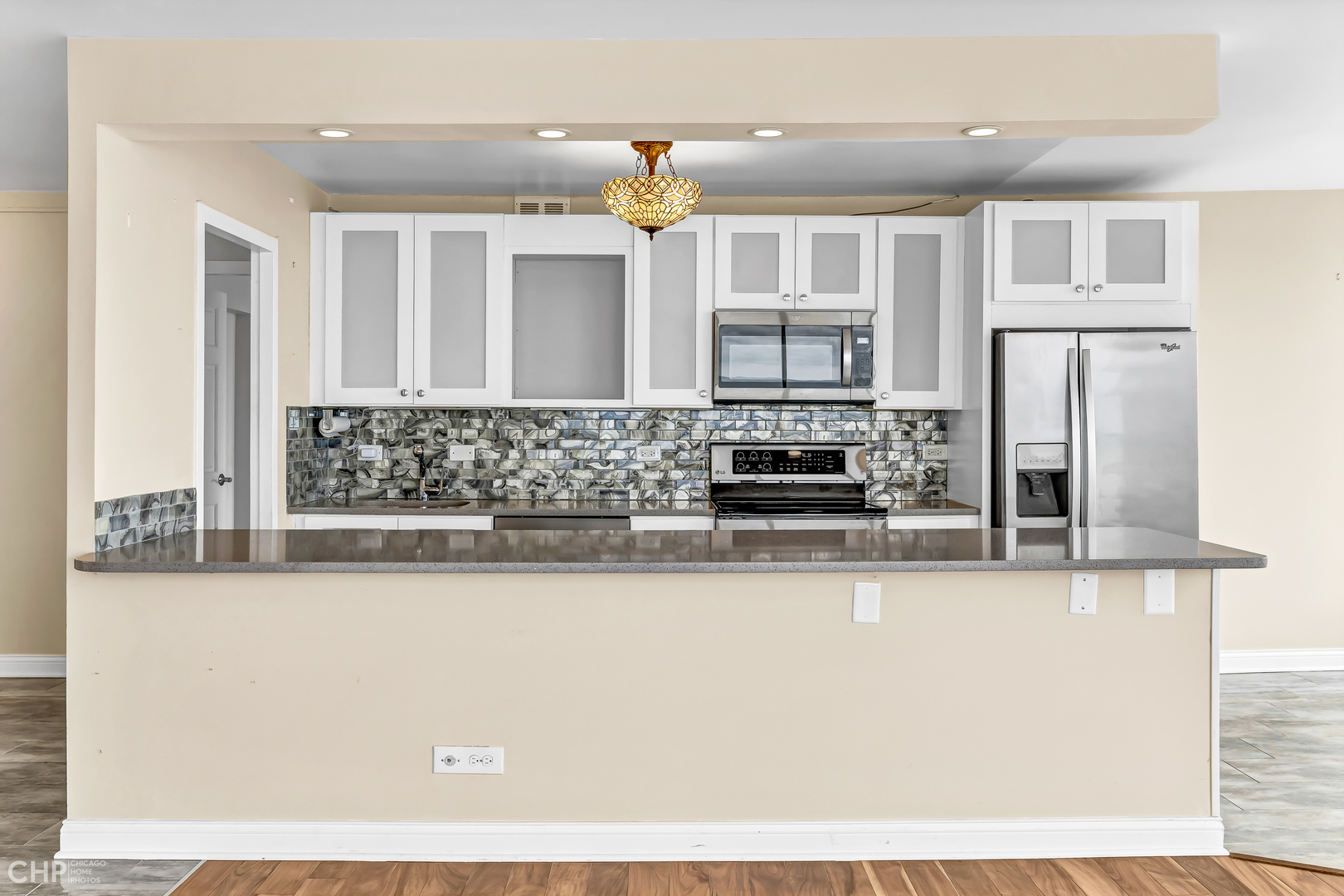 5455 North Sheridan Road, Unit 3501 Chicago, IL 60640 - Photo 5 of 29 a kitchen with stainless steel appliances kitchen island granite countertop a refrigerator and microwave