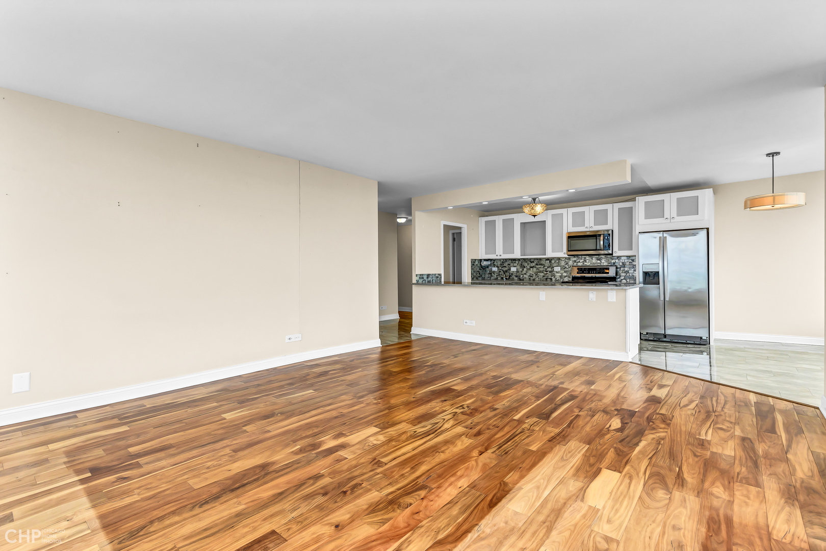 5455 North Sheridan Road, Unit 3501 Chicago, IL 60640 - Photo 9 of 29 a view of a kitchen with wooden floor and a sink
