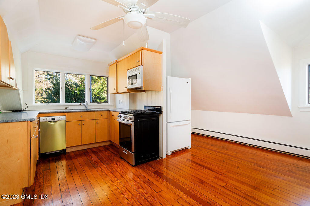 41 B Byram Shore Road Greenwich, CT 06830 - Photo 5 of 16 a kitchen with wooden floors and a white stove
