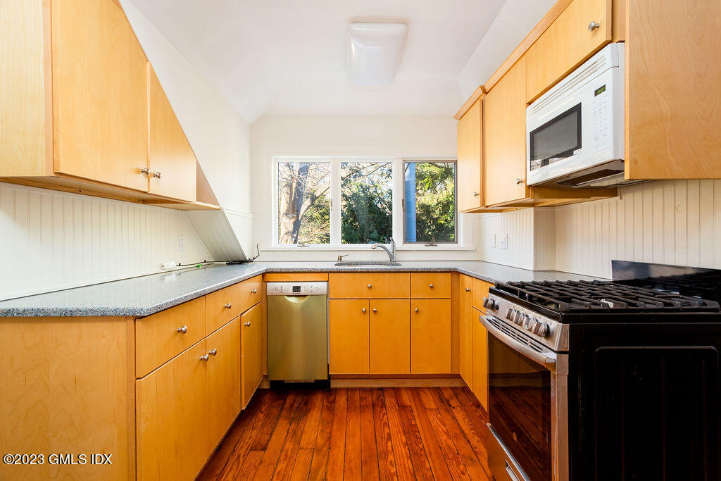 41 B Byram Shore Road Greenwich, CT 06830 - Photo 6 of 16 a kitchen with stainless steel appliances a stove a sink and a microwave