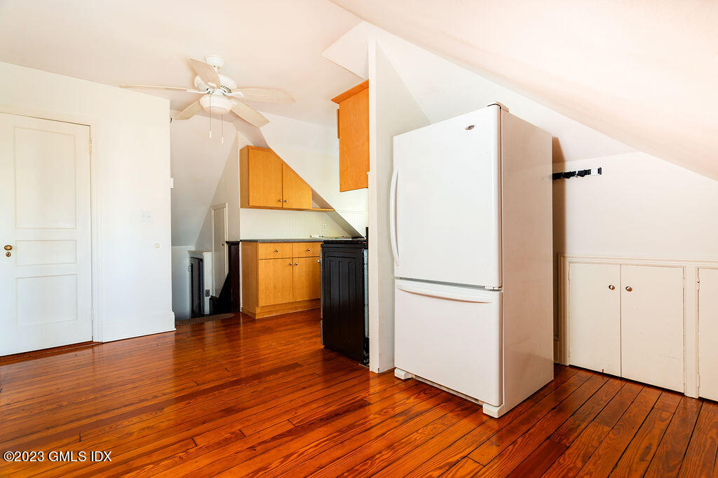 41 B Byram Shore Road Greenwich, CT 06830 - Photo 8 of 16 a view of a room with wooden floor and a refrigerator