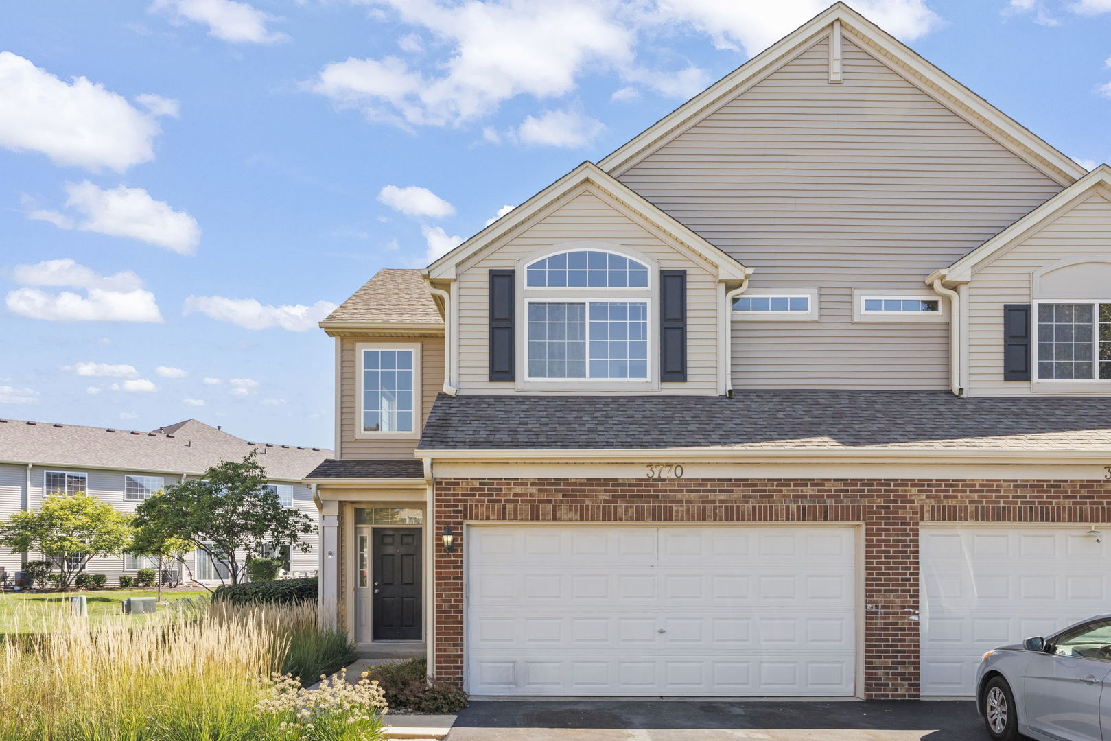 a front view of a house with a yard and garage