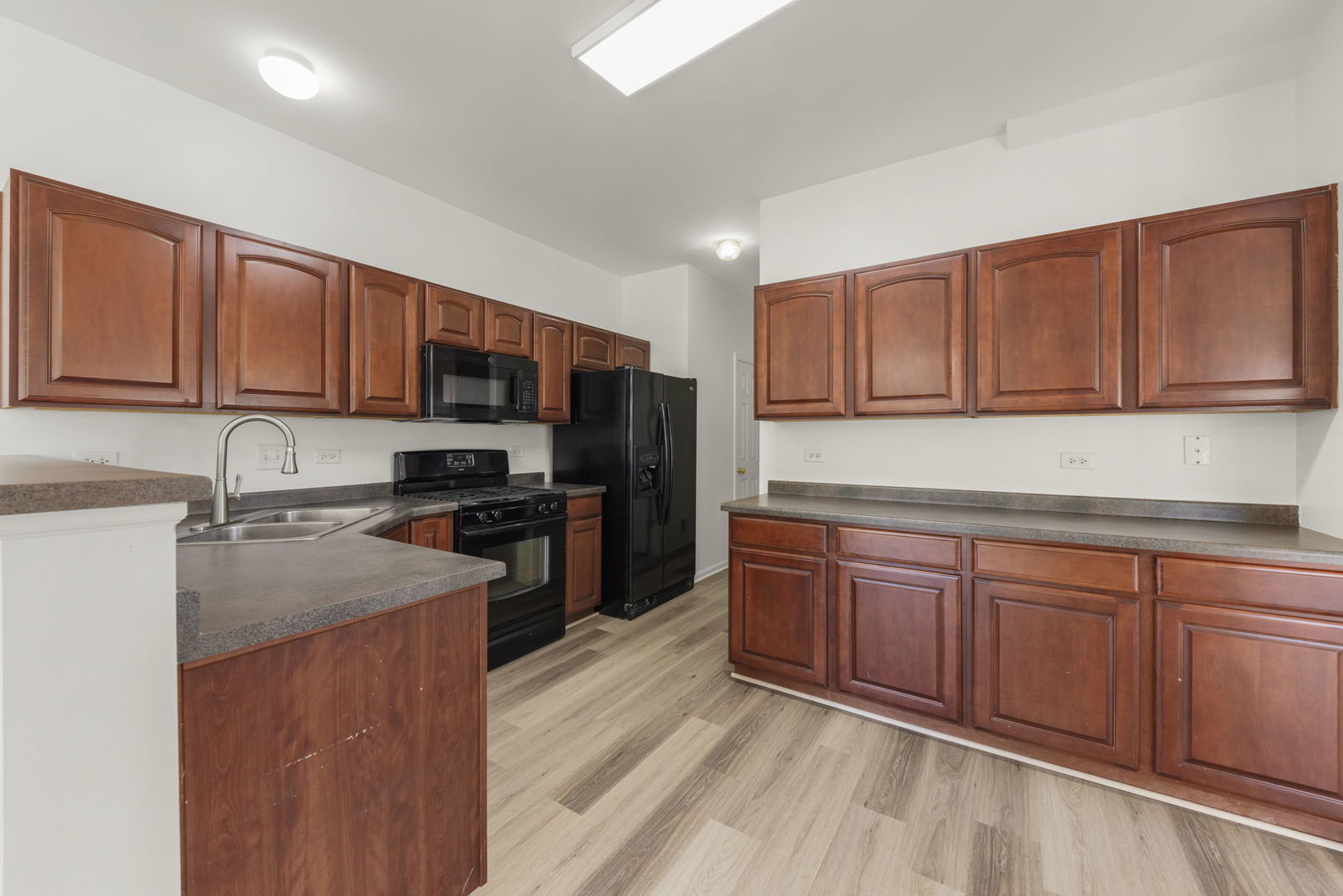 3770 Pope Court Plano, IL 60545 - Photo 3 of 25 a kitchen with wooden cabinets stainless steel appliances and a sink