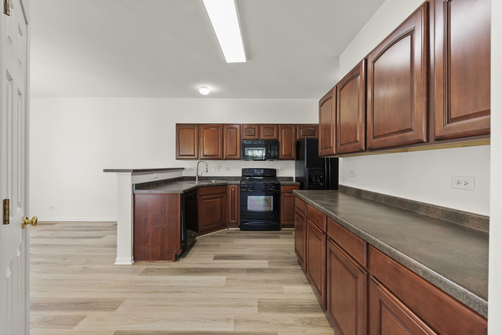 3770 Pope Court Plano, IL 60545 - Photo 5 of 25 a kitchen with stainless steel appliances granite countertop a stove a sink dishwasher a microwave oven and a refrigerator
