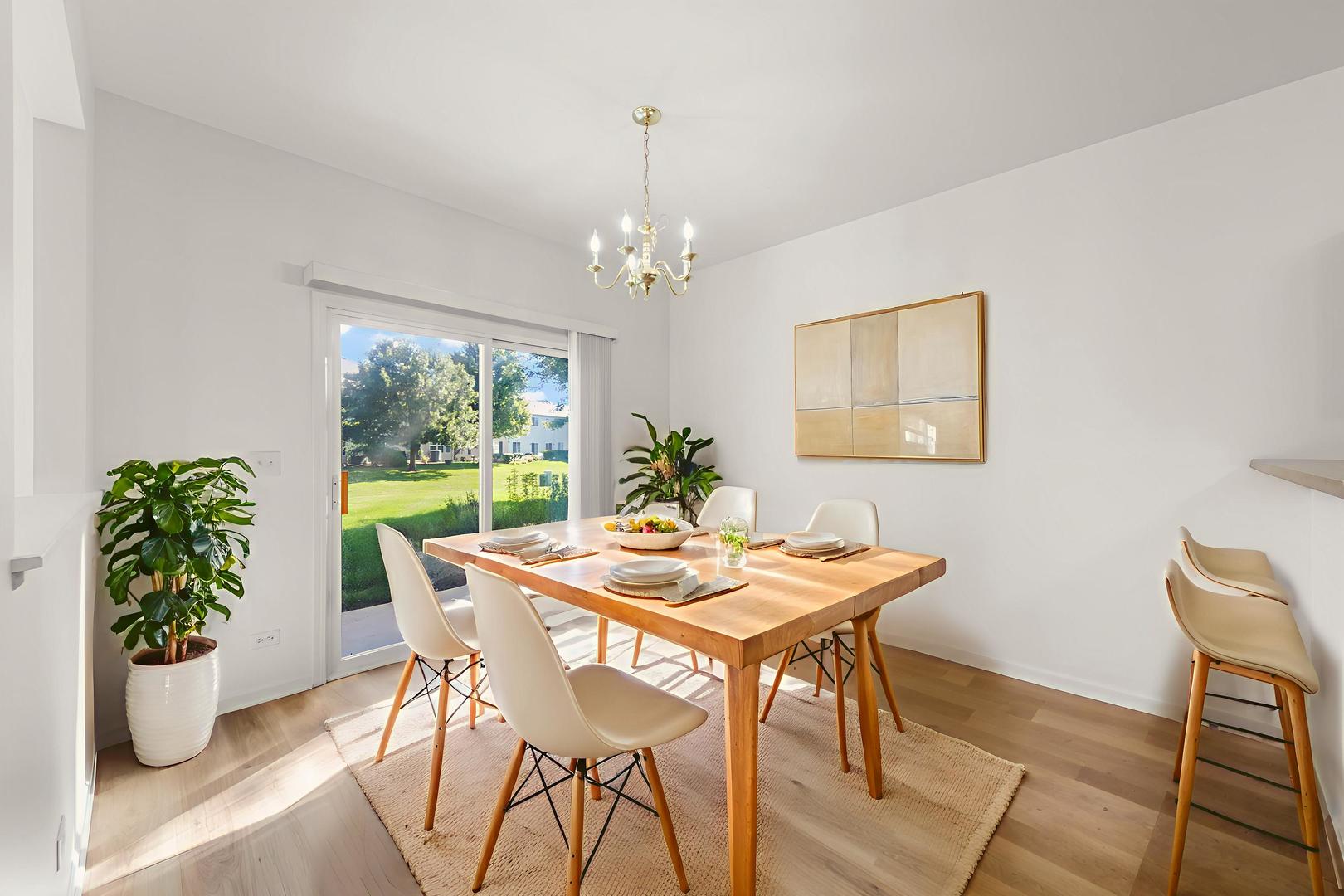 3770 Pope Court Plano, IL 60545 - Photo 7 of 25 a view of a dining room with furniture and chandelier
