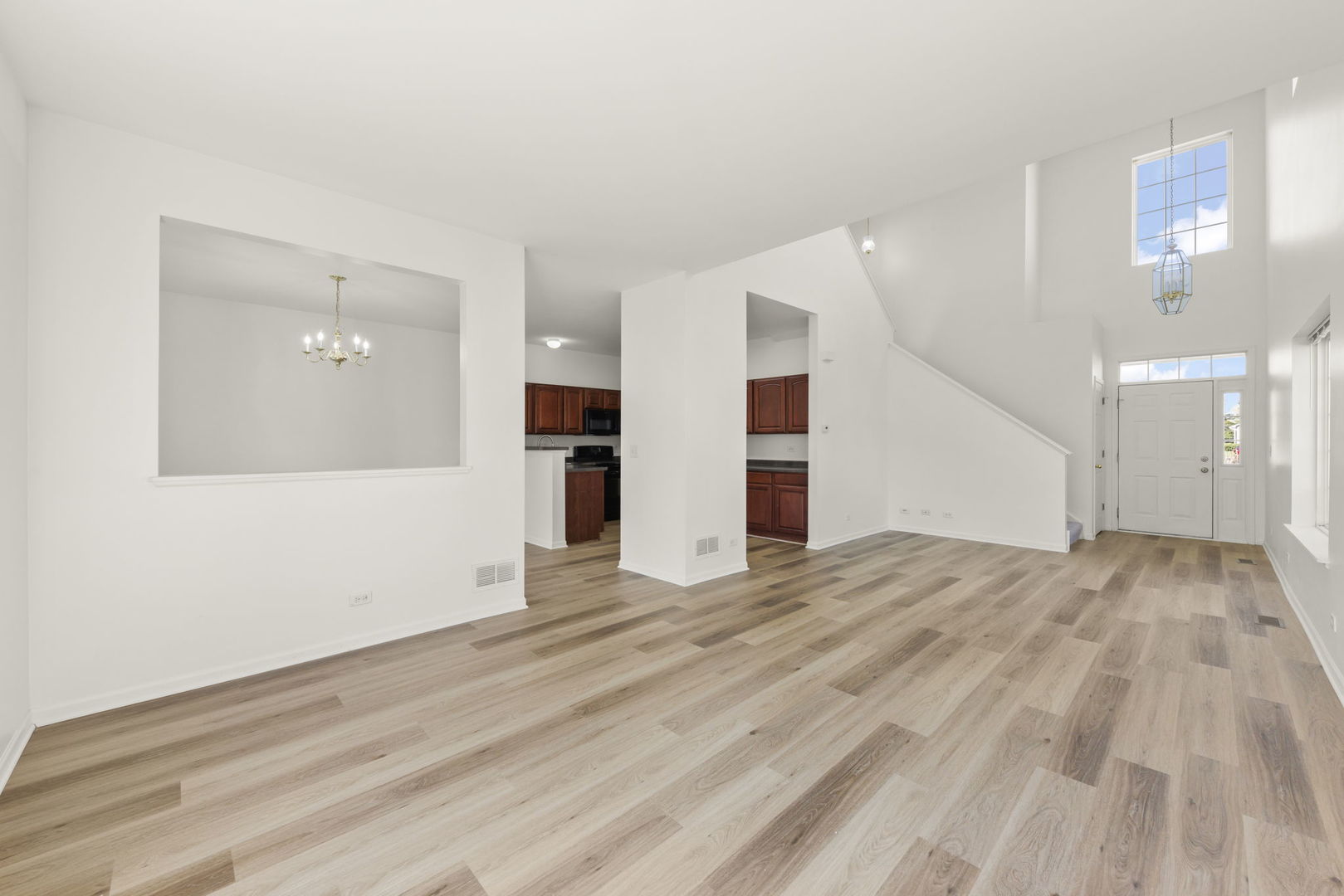 3770 Pope Court Plano, IL 60545 - Photo 10 of 25 a view of empty room with wooden floor and windows