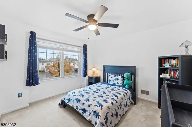 a bedroom with a bed and a dresser in it