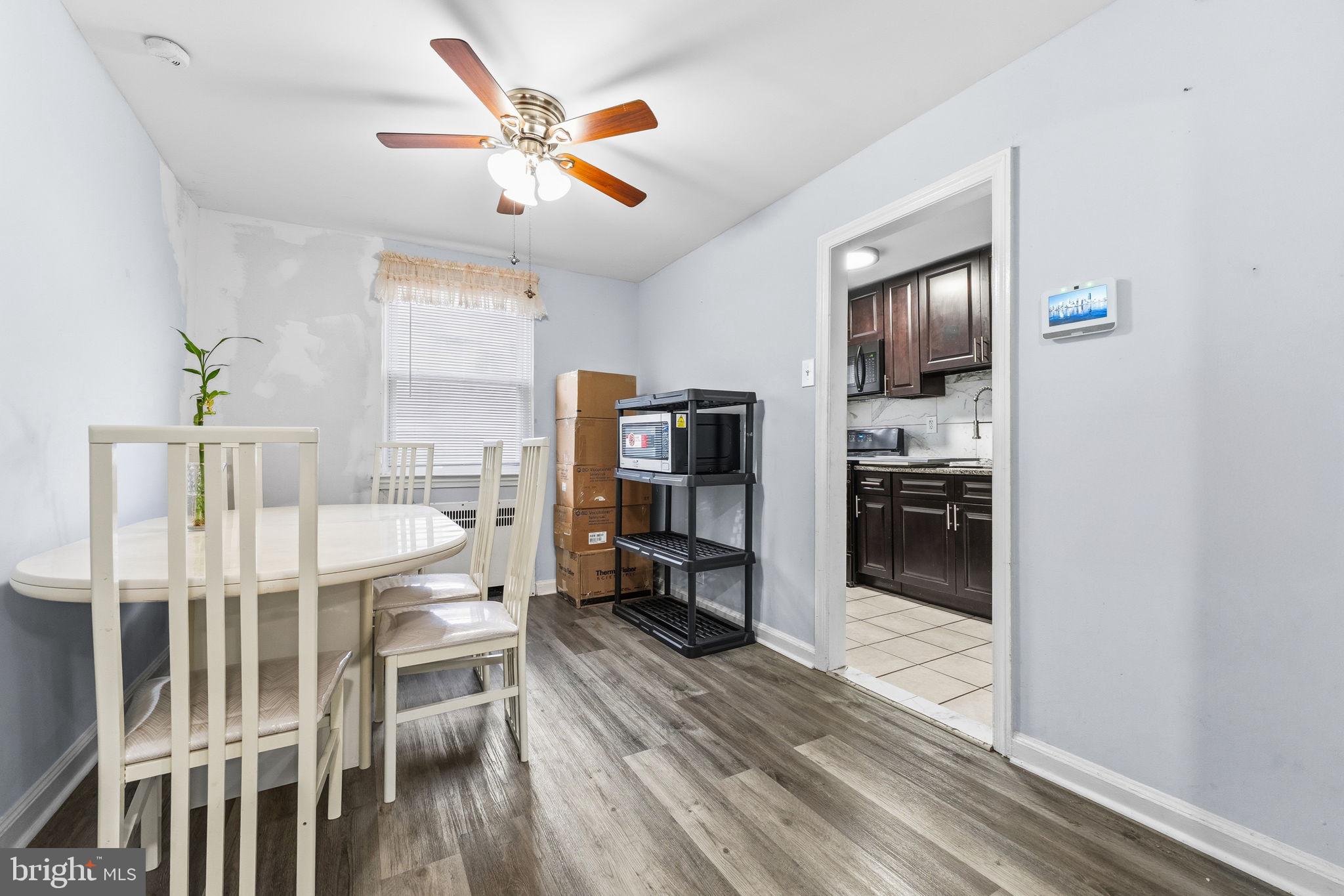 540 Snowden Road Upper Darby, PA 19082 - Photo 6 of 30 a dining room with wooden floor a ceiling fan and a window