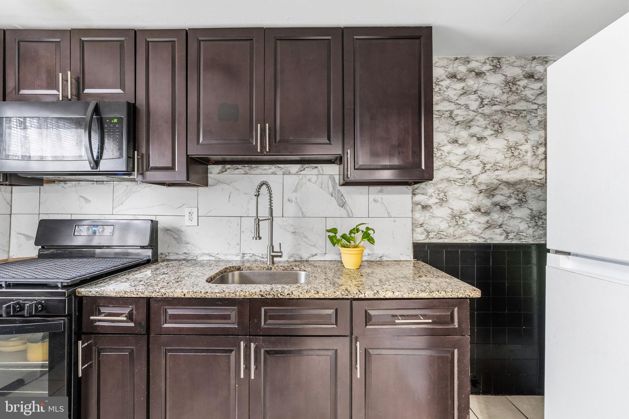 540 Snowden Road Upper Darby, PA 19082 - Photo 10 of 30 a kitchen with granite countertop wood cabinets and granite counter tops